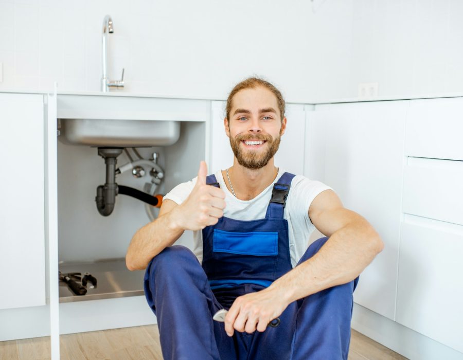 Handsome plumber at the kitchen Handsome plumber at the kitchen